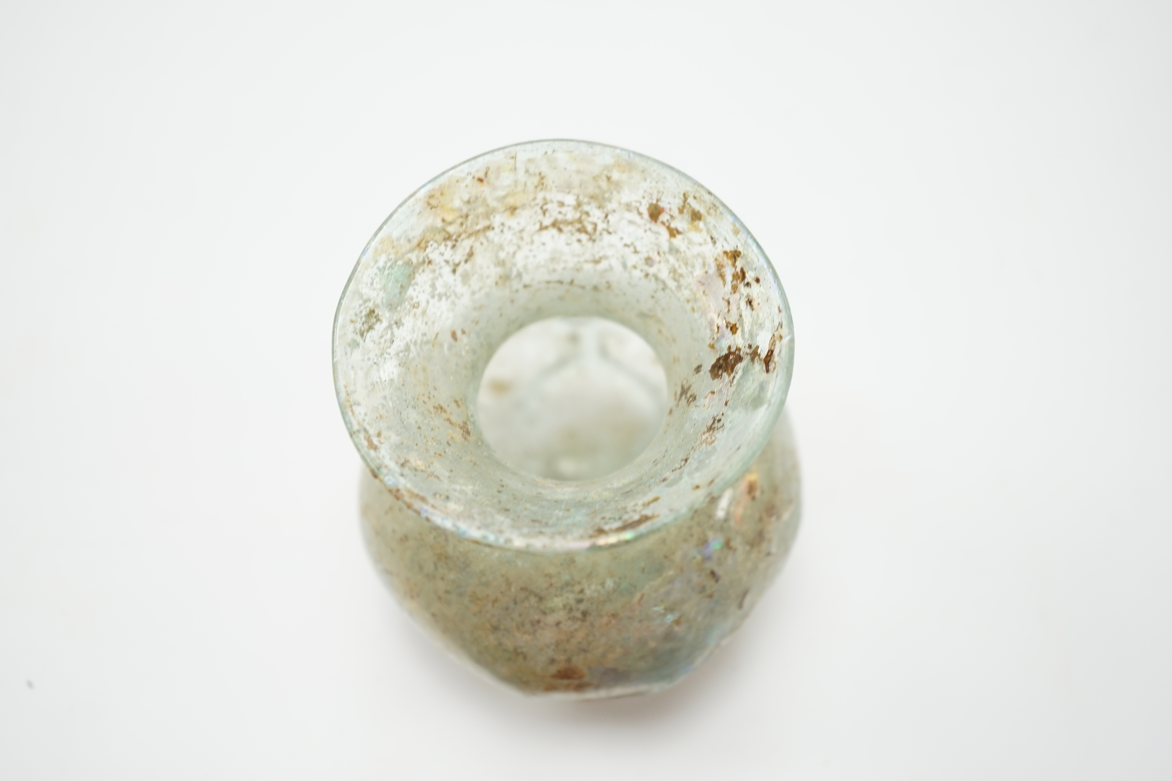 A Roman iridescent glass vessel on stand, 8cm high